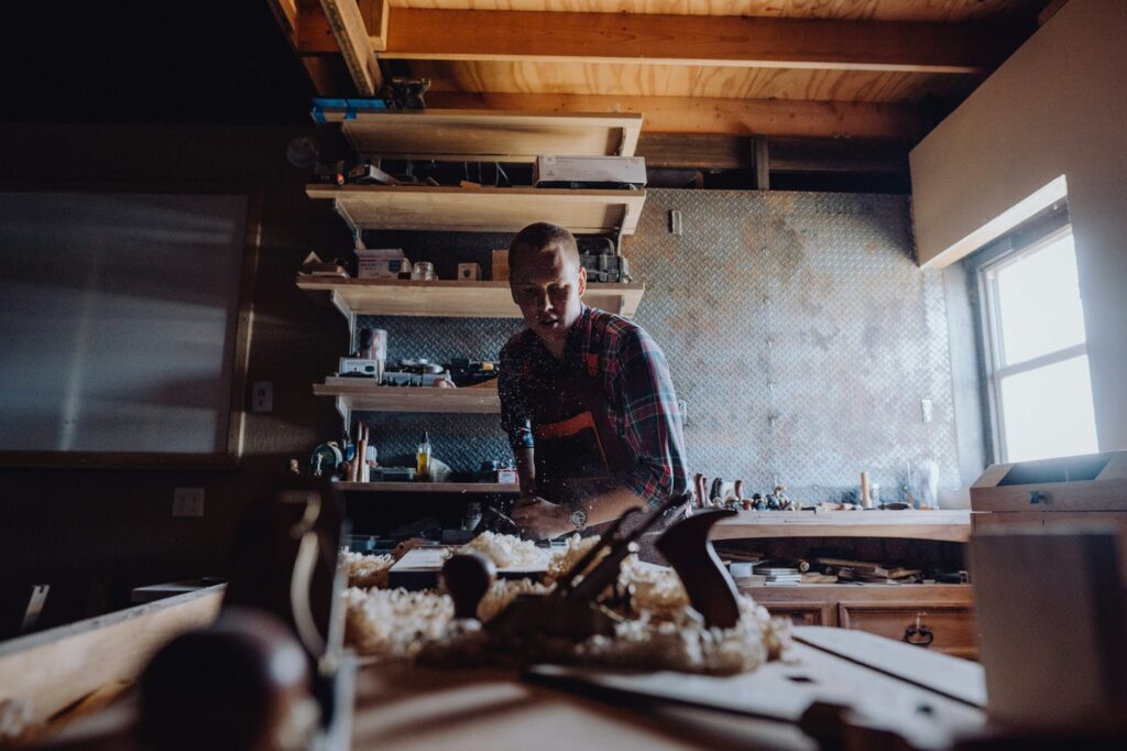 Craftsman working wood in CNC cabinetry workshop