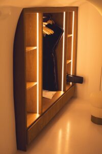 Cozy modern wooden custom closet with warm lighting